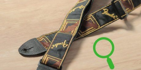 Come attaccare una tracolla per chitarra alla tua chitarra